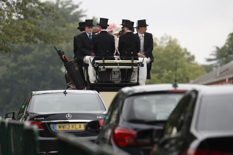 Racegoers arrive on the second day of the annual Royal Ascot horse race meeting in Ascot, England, Wednesday, June 19, 2019. (AP Photo/Alastair Grant)