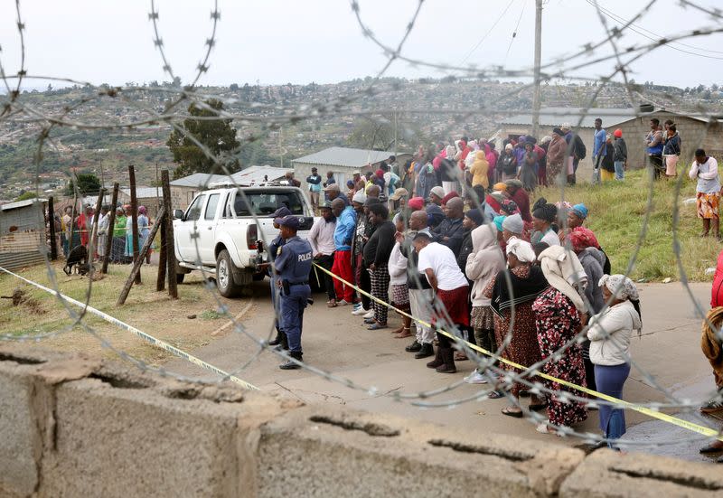 Residents look on at the scene of a deadly mass shooting near Pietermaritzburg