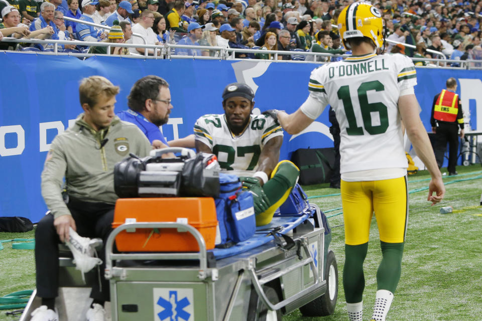 Green Bay Packers wide receiver Romeo Doubs is helped off the field during the first half of an NFL football game against the Detroit Lions, Sunday, Nov. 6, 2022, in Detroit. (AP Photo/Duane Burleson)