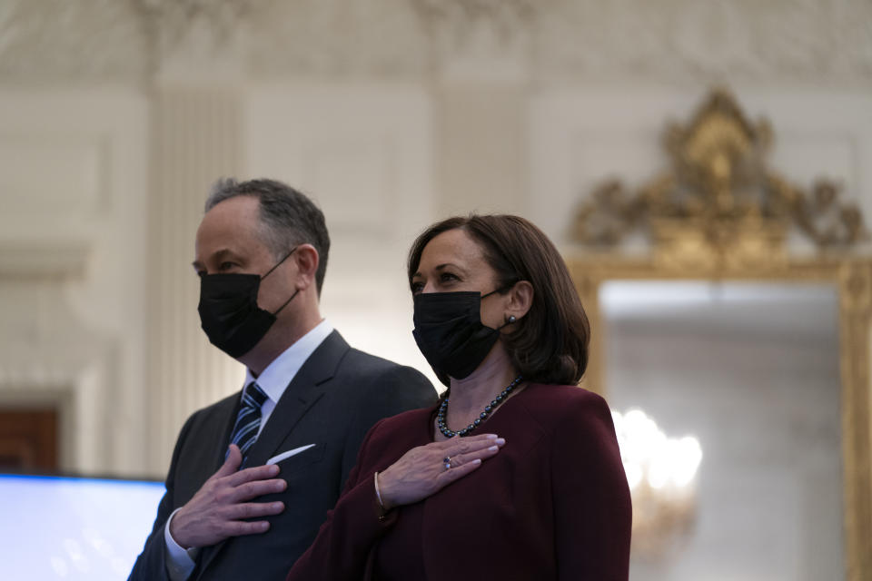 Vice President Kamala Harris, and her husband Doug Emhoff, place their hands over their hearts during a performance of the national anthem, during a virtual Presidential Inaugural Prayer Service, in the State Dinning Room of the White House, Thursday, Jan. 21, 2021, in Washington. (AP Photo/Alex Brandon)