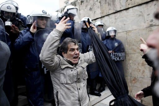 Protesters clash with riot police as they try to enter the parliament during a 24-hour general strike in Athens. Greeks raged against wage and pension cuts being imposed on their country