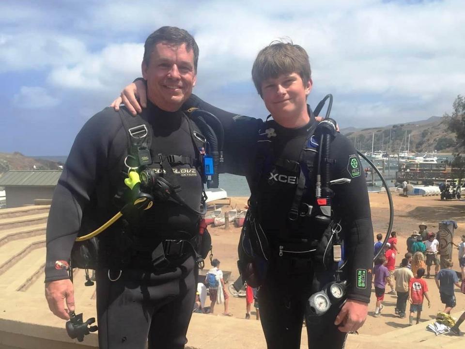 Dave Cantin and his son, Jack, are pictured in scuba diving gear.