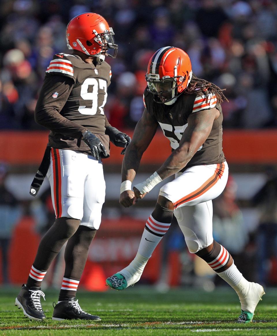 Browns defensive end Takkarist McKinley (55) celebrates after getting to Ravens quarterback Lamar Jackson during the first half Sunday, Dec. 12, 2021, in Cleveland.