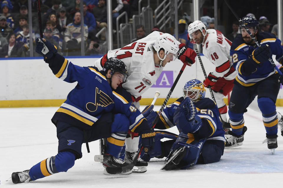 Carolina Hurricanes' Jesper Fast (71) attempts a shot on goal against St. Louis Blues' Torey Krug (47) and Jordan Binnington (50) during the first period of an NHL hockey game Thursday, Dec. 1, 2022, in St. Louis. (AP Photo/Michael Thomas)