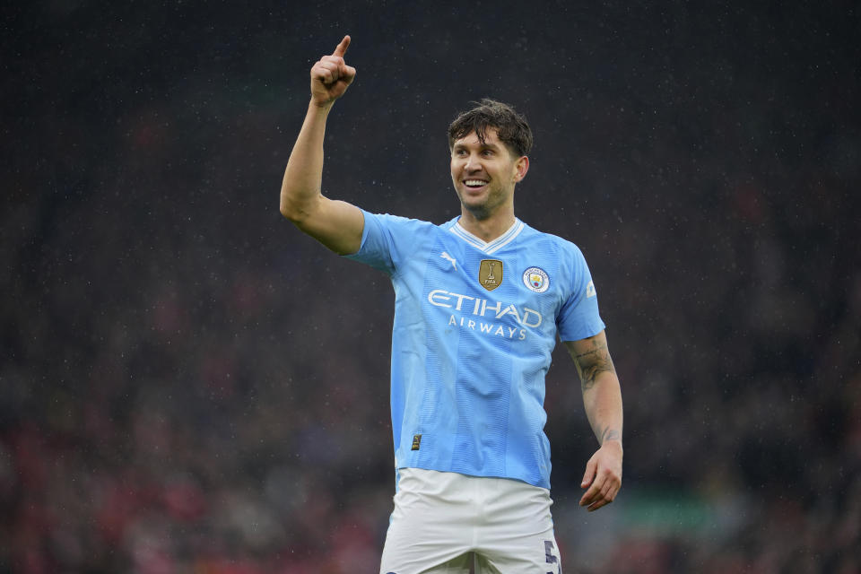 Manchester City's John Stones celebrates after scoring the opening goal of his team during the English Premier League soccer match between Liverpool and Manchester City, at Anfield stadium in Liverpool, England, Sunday, March 10, 2024. (AP Photo/Jon Super)