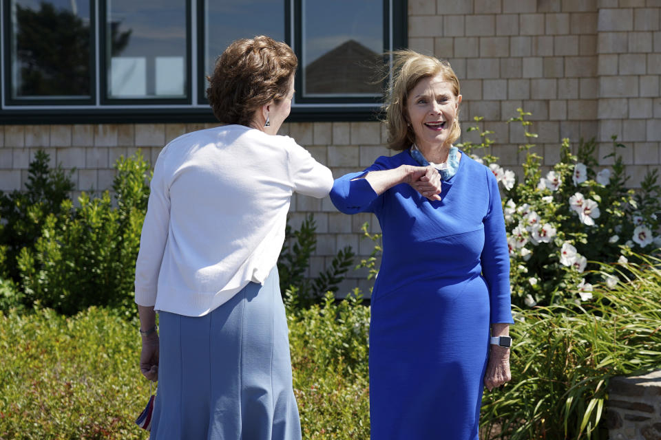 Former first lady Laura Bush gives an elbow bump to Sen. Susan Collins, R-Maine, Friday, Aug. 21, 2020, in Kennebunkport, Maine. (AP Photo/Mary Schwalm)