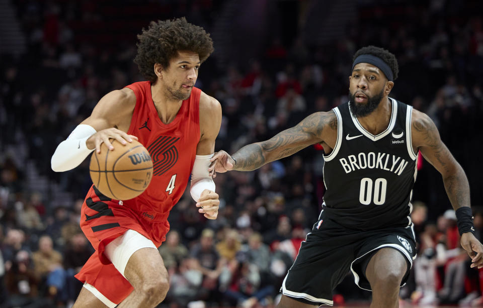 Portland Trail Blazers guard Matisse Thybulle, left, drives past Brooklyn Nets forward Royce O'Neale during the first half of an NBA basketball game in Portland, Ore., Wednesday, Jan. 17, 2024. (AP Photo/Craig Mitchelldyer)