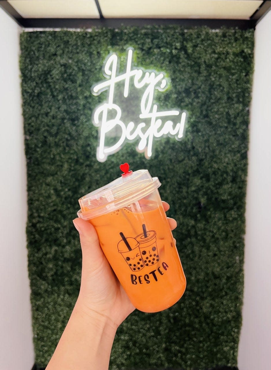 Bestea's owner Lina Yang holds a cup of Thai tea, one offering at the new bubble tea shop on Michigan Ave. in Sheboygan.