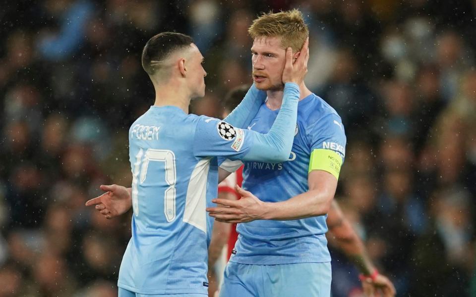 Manchester City's Kevin De Bruyne, right, celebrates with his teammate Phil Foden at the end of the Champions League, first leg, quarterfinal soccer match between Manchester City and Atletico Madrid - AP Photo/Dave Thompson