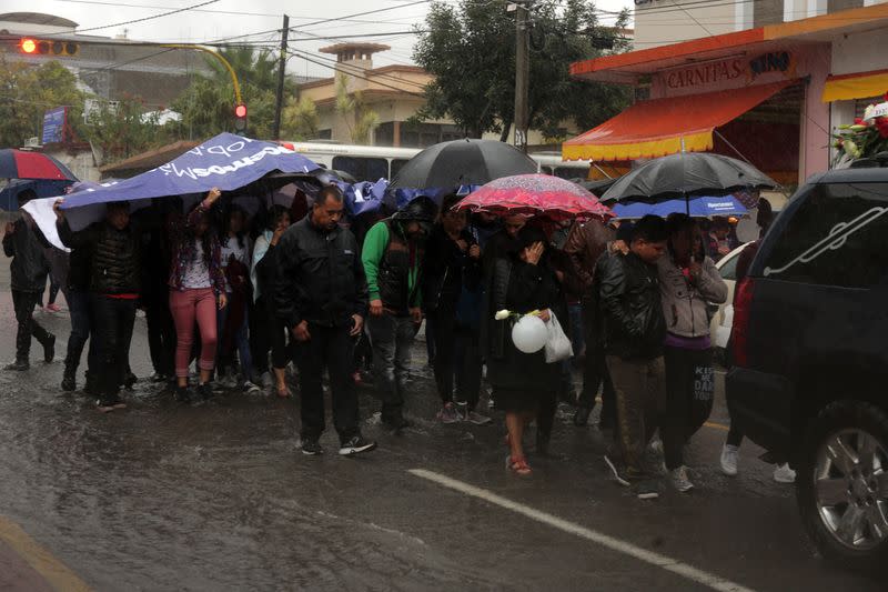 People attend the funeral of several of the victims killed by shooters at a slot-machine arcade in the central Mexican state of Michoacan, in Uruapan