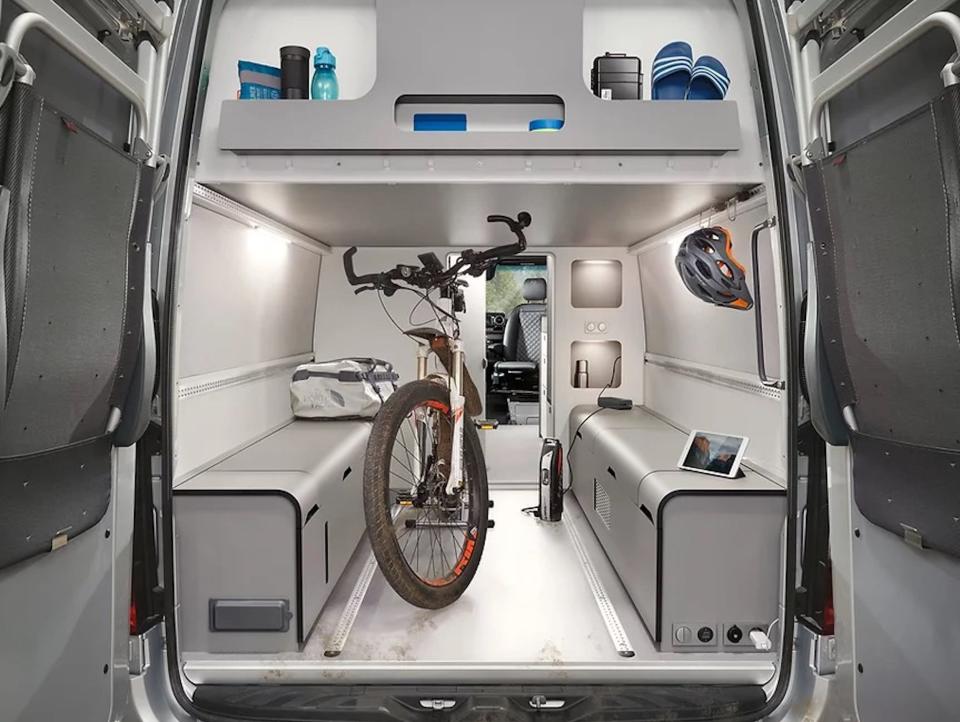 A bike sitting inside the garage at the rear of the van.