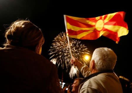 Supporters of the ruling Social Democratic Union of Macedonia wave a Macedonian flag during victory celebrations for the local elections in Skopje, Macedonia, October 16, 2017.REUTERS/Ognen Teofilovski