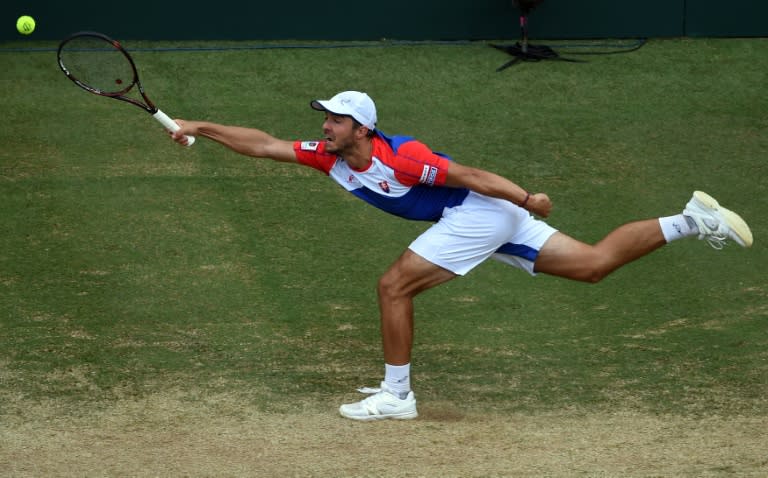 Slovakia's Andrej Martin hits a return against Australia's Nick Kyrgios in their men's singles tennis match during the Davis Cup World Group playoff between Australia and Slovakia in Sydney on September 16, 2016