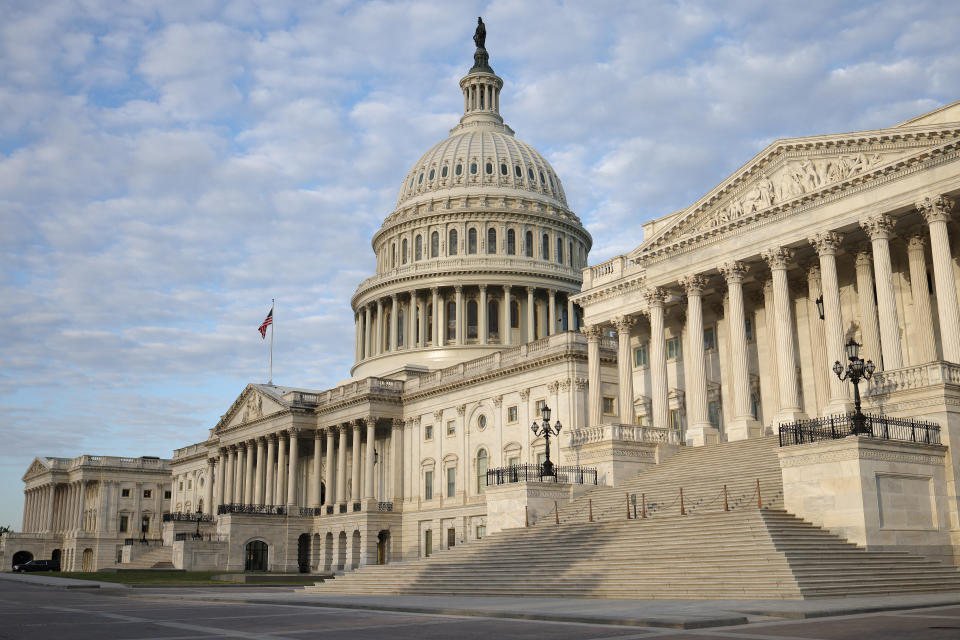 The U.S. Capitol building against a blue sky filled with wispy clouds.