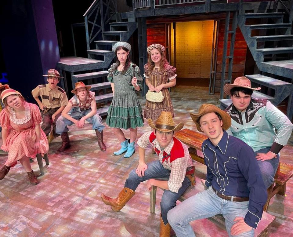 The ranchers meet to discuss the horrible problem of missing cows in a rehearsal for "Bat Boy" at Pelham Memorial High School. They are, from left: Maddy Lyons as Lorraine, Jeremy Tam as Sheriff, Quentin Meyer as Ned, Leah Sherbansky as Mayor Maggie, Leila Brady as Daisy, William Russello as Roy, Owen Cuomo as Dillon & Daniel O'Keefe as Bud.