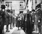 <p>Queen Elizabeth walks through ranks of Yeomen of the Guard after leaving the Royal Maundy Service at Westminster Abbey. (PA) </p>