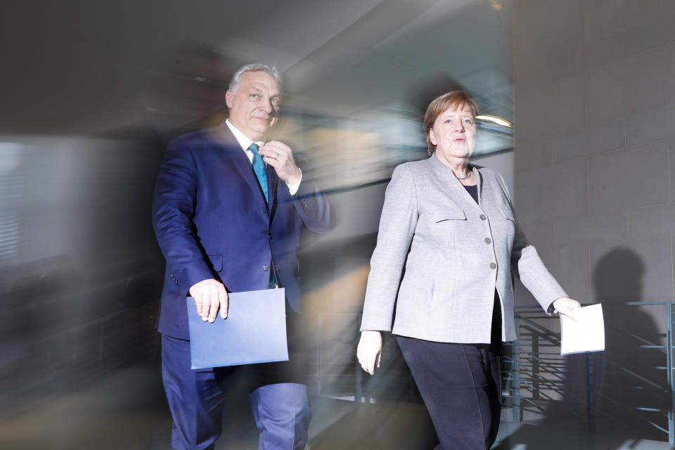 FILE - In this Monday, Feb. 10, 2020 file photo German Chancellor Angela Merkel, right, and Hungary's Prime Minister Victor Orban, left, arrive for a statement prior to a meeting at the chancellery in Berlin, Germany. (AP Photo/Markus Schreiber, File)