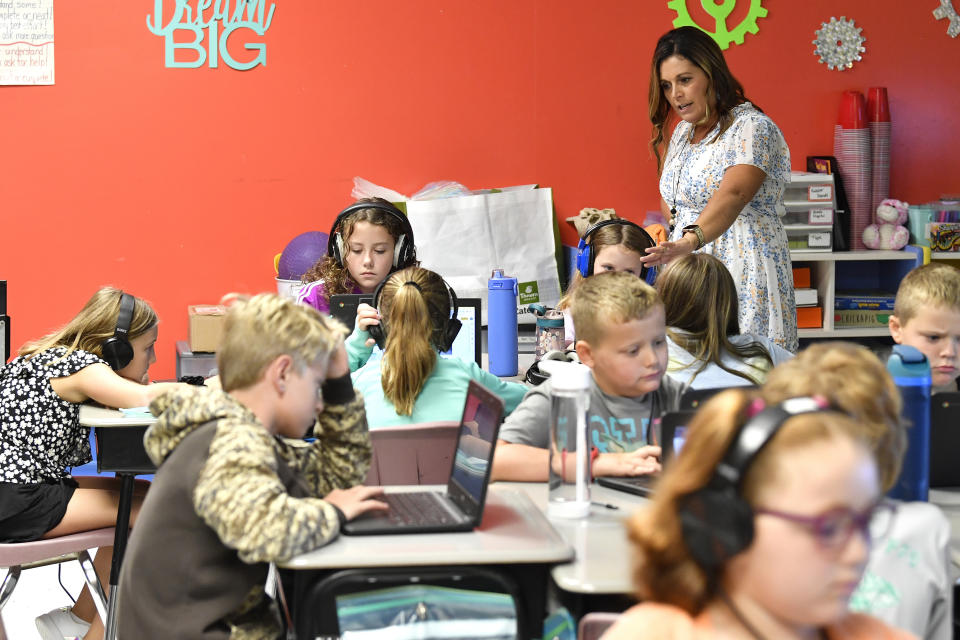 Angela Pike watches her fourth grade students at Lakewood Elementary School in Cecilia, Ky., as they use their laptops to participate in an emotional check-in at the start of the school day, Thursday, Aug. 11, 2022. The rural Kentucky school is one of thousands across the country using the technology to screen students' state of mind and alert teachers to anyone struggling. (AP Photo/Timothy D. Easley)