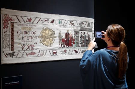 A visitor takes a picture of the Game of Thrones Tapestry in Bayeux