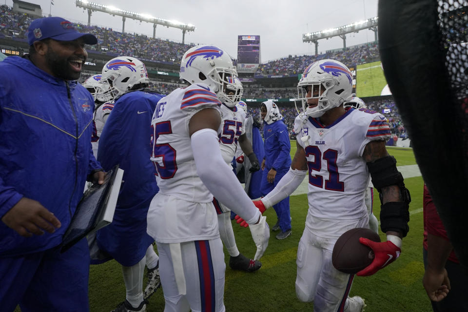 Buffalo Bills safety Jordan Poyer (21) is congratulated after intercepting a pass against the Baltimore Ravens in the second half of an NFL football game Sunday, Oct. 2, 2022, in Baltimore. (AP Photo/Julio Cortez)