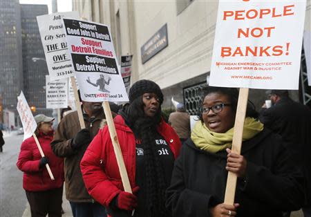 Protesters rally outside the Detroit Federal Court House during a bankruptcy hearing declaring Detroit is eligible for the biggest municipal bankruptcy in U.S. history, in Detroit, Michigan December 3, 2013. (REUTERS/Rebecca Cook)