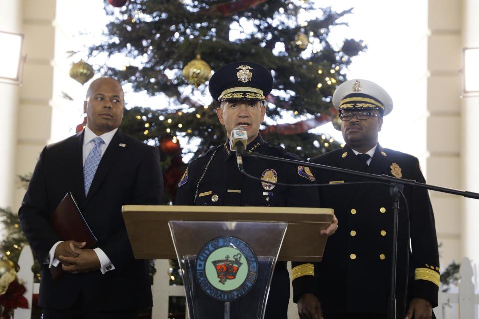Pasadena Police Chief Phillip Sanchez, center, speaks about safety issues ahead of next week's 128th Rose Parade as he is joined by Pasadena Fire Chief Bertral Washington, background right, and Rob Savage, special agent in charge of the U.S. Secret Service Wednesday, Dec. 28, 2016, in Pasadena, Calif. (AP Photo/Jae C. Hong)