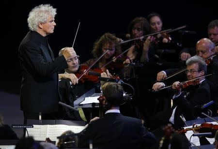 Conductor Simon Rattle takes part in the opening ceremony of the London 2012 Olympic Games at the Olympic Stadium July 27, 2012. REUTERS/Mike Blake