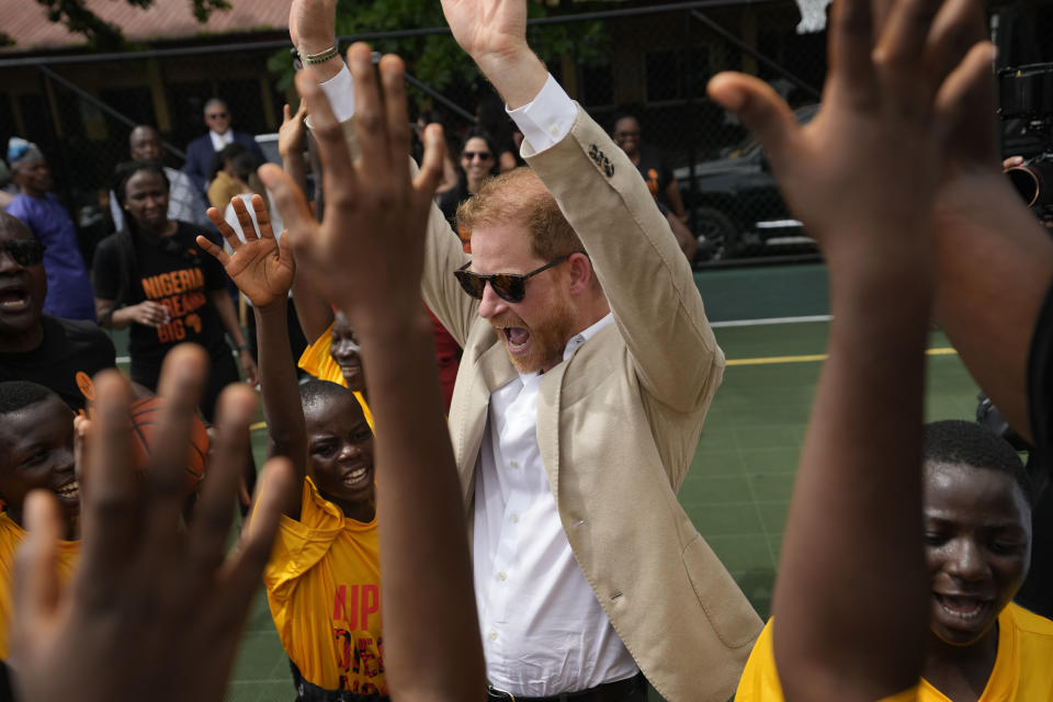 Prince Harry, chants with children during the Giant of Africa Foundation at the Dream Big Basketball clinic in Lagos Nigeria, Sunday, May 12, 2024. Prince Harry and his wife Meghan are in Nigeria to champion the Invictus Games, which Prince Harry founded to aid the rehabilitation of wounded and sick servicemembers and veterans. (AP Photo/Sunday Alamba)
