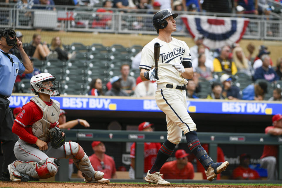 Minnesota Twins' Max Kepler, right, and Los Angeles Angels catcher Logan O'Hoppe, second from left, watch Kepler's hit go over the fence for a two-run home run during the first inning of a baseball game Sunday, Sept. 24, 2023, in Minneapolis. (AP Photo/Craig Lassig)
