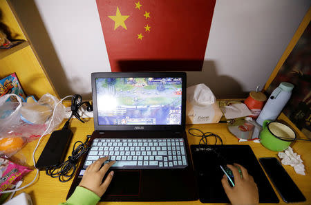 A student majoring esports and management practices on her laptop in a dormitory at the Sichuan Film and Television University in Chengdu, Sichuan province, China, November 19, 2017. REUTERS/Tyrone Siu