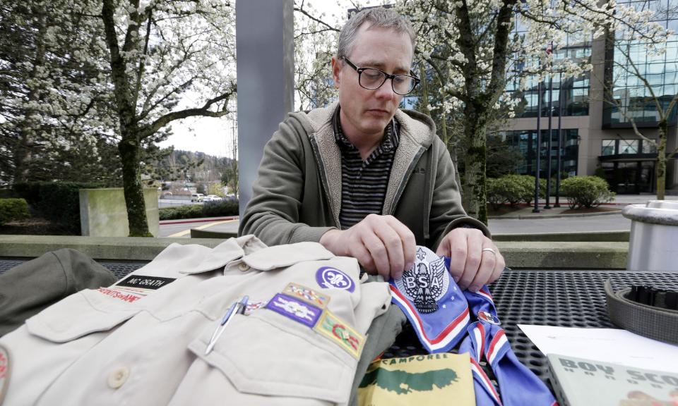 Geoff McGrath displays his Boy Scout scoutmaster uniform shirt and other scout items for the Seattle troop he led, Tuesday, April 1, 2014, in Bellevue, Wash. The Boys Scouts of America has removed McGrath, an openly gay troop leader, after saying he made an issue out of his sexual orientation. The BSA told McGrath in a letter Monday that “it has no choice but to revoke your registration” after he told news media he was gay in connection with a news story. McGrath, who earned the rank of Eagle Scout, has been leading Seattle Troop 98 since its application was approved last fall. (AP Photo/Elaine Thompson)