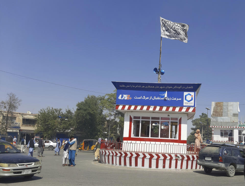 A Taliban flag flies in the main square of Kunduz city after fighting between Taliban and Afghan security forces, in Kunduz, Afghanistan, Sunday, Aug. 8, 2021. Taliban fighters Sunday took control of much of the capital of northern Afghanistan's Kunduz province, including the governor's office and police headquarters, a provincial council member said. (AP Photo/Abdullah Sahil)