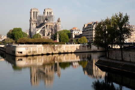 A view shows Notre-Dame Cathedral reflected on the River Seine after a massive fire devastated large parts of the gothic structure in Paris, France, April 18, 2019. REUTERS/Philippe Wojazer