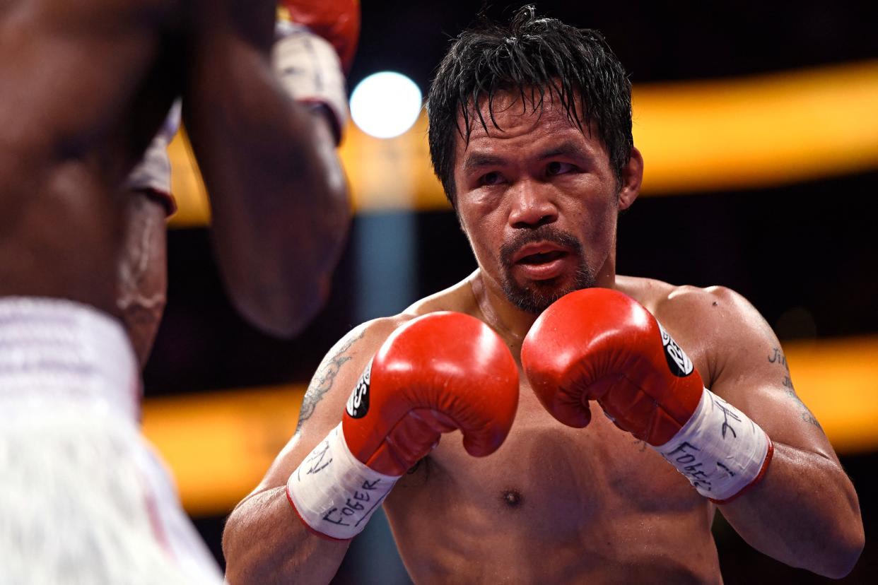 Manny Pacquiao (R) of the Philippines fights against Yordenis Ugas of Cuba during the WBA Welterweight Championship boxing match at T-Mobile Arena in Las Vegas, Nevada on August 21, 2021. - Cuba's Yordenis Ugas upset Manny Pacquiao to retain his WBA welterweight crown on Saturday, winning by unanimous decision after a bruising 12-round battle at the T-Mobile Arena. (Photo by Patrick T. FALLON / AFP) (Photo by PATRICK T. FALLON/AFP via Getty Images)