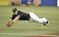 TORONTO, CANADA - AUGUST 9: Brett Lawrie #13 of the Toronto Blue Jays makes a diving stop before throwing on to first during MLB game action against the Oakland Athletics August 9, 2011 at Rogers Centre in Toronto, Ontario, Canada. (Photo by Brad White/Getty Images)