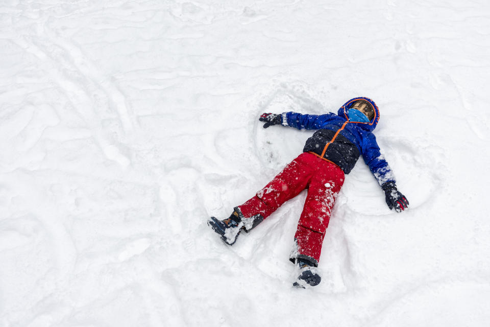 Arlo Dalili, 5, makes a snow angels in the fresh snow at Rittenhouse Square in Philadelphia, Friday, Jan. 19, 2024. (Tyger Williams/The Philadelphia Inquirer via AP)