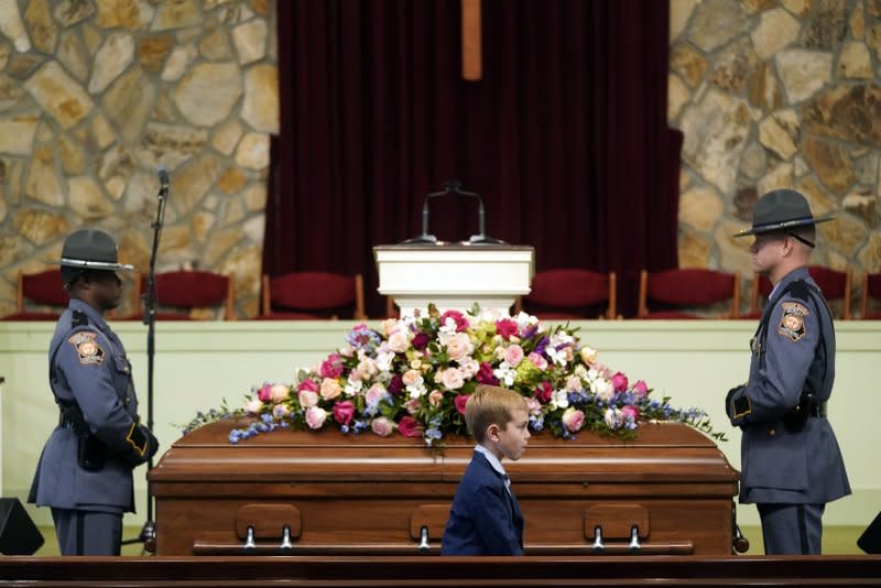 A young mourner walks past the casket at Wednesday's funeral service for former first lady Rosalynn Carter at Maranatha Baptist Church in Plains, Ga. Pool Photo by Alex Brandon/UPI