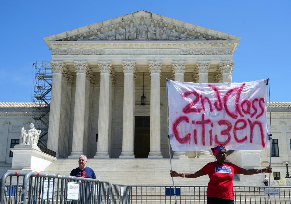 A demonstrator stands outside the Supreme Court as the court is slated to make a decision on abortion pills Wednesday, April 19, 2023. Earlier in April, a Trump appointed judge in Texas suspended approval of mifepristone, an FDA approved abortion pill.