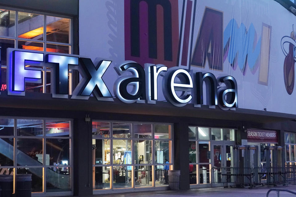 Signage for the FTX Arena, where the Miami Heat basketball team plays, is illuminated Saturday, Nov. 12, 2022, in Miami. Collapsed cryptocurrency trading firm FTX confirmed there was “unauthorized access” to its accounts, hours after the company filed for Chapter 11 bankruptcy protection Friday, Nov. 11. (AP Photo/Marta Lavandier)