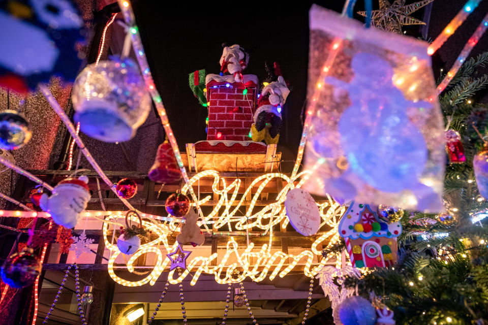 The Christmas lights are turned at the home of Dave Edwards known as Mr Christmas  who passed away on Friday night. See SWNS story SWCAchristmas. The daughter of an OAP known as 'Mr Christmas' fulfilled her father's dying wish last night (Sat) and switched on his dazzling light display - just 24 hours after he passed away. Dave Edwards, 86, became a local celebrity in his village of Croxley Green, Watford, Herts., for covering his house with amazing light displays over the last 42 years. Every year the grandfather-of-two went bigger and better as he added more lights to his collection, turning his home and garden into a Christmas wonderland. The real-life 'Mr Christmas' had raised hundreds of pounds for charities over the years, as hundreds of people traditionally gathered in the street to watch the switch-on event.