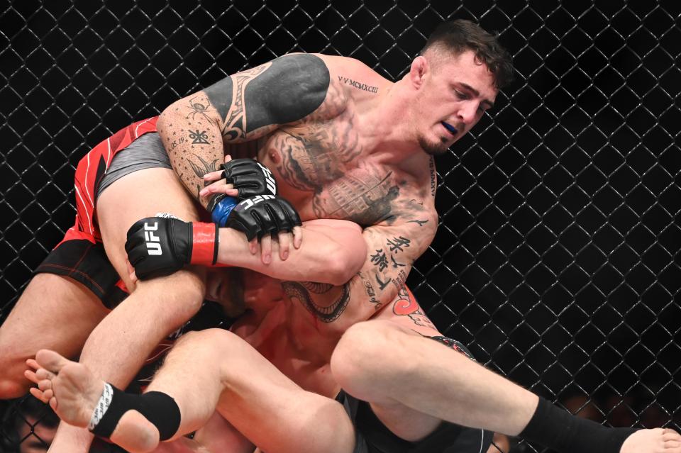 Mar 19, 2022; London, UK; Alexander Volkov (red gloves) and Tom Aspinall (blue gloves) during UFC Fight Night at O2 Arena. Mandatory Credit: Per Haljestam-USA TODAY Sports