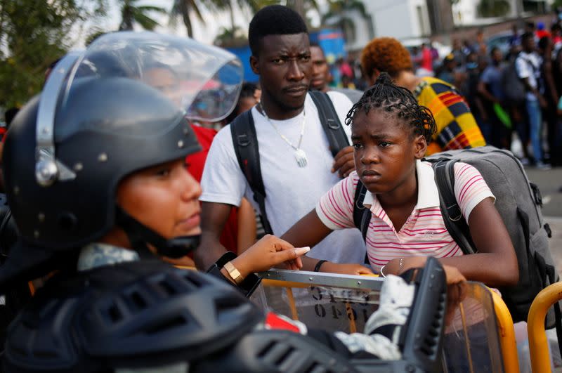 Migrants queue to get on buses after accepting an offer from the Mexican government to obtain humanitarian visas, in Tapachula