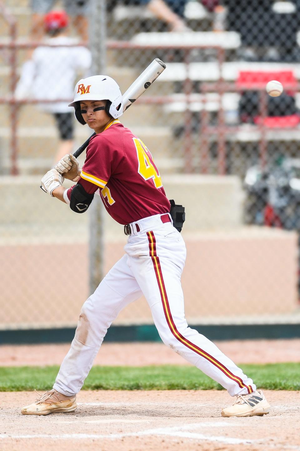 Rocky Mountain's Nate Eliason (47) turns away from a high pitch during a Class 5A state baseball tournament game against Valor Christian at All-City Park in Denver on Friday.