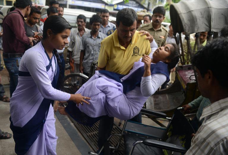 Indian hospital staff attend to a schoolgirl who fainted as a tremor struck Siliguri, on May 12, 2015