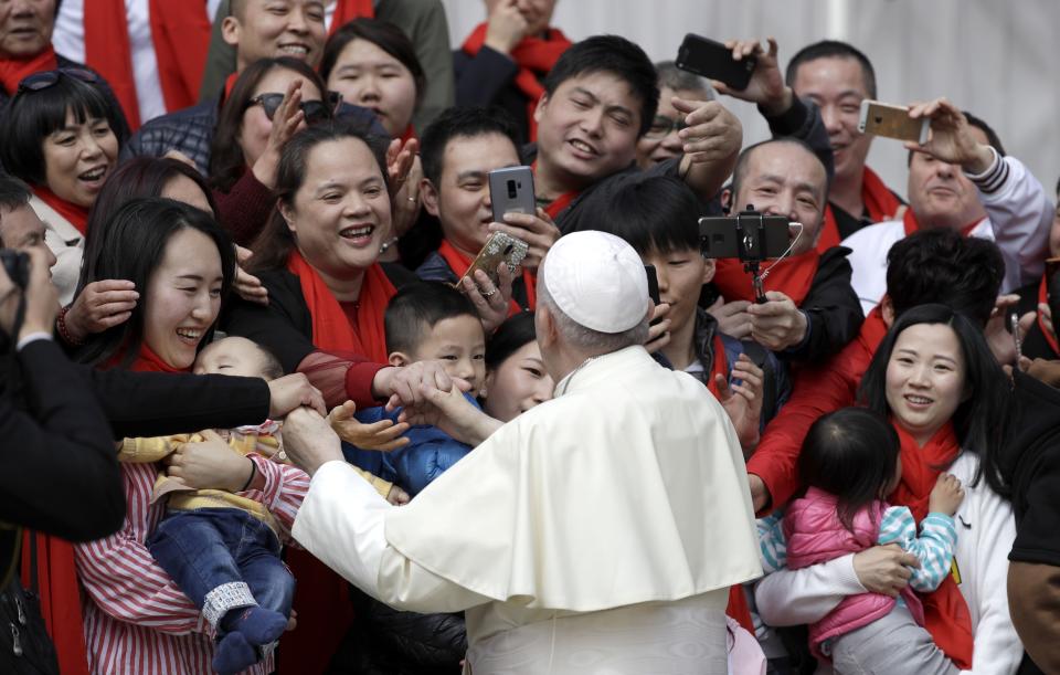 FILE - In this April 18, 2018 file photo, Pope Francis meets a group of faithful from China at the end of his weekly general audience in St. Peter's Square, at the Vatican. On Saturday, Sept. 22, 2018, the Vatican announced it had signed a "provisional agreement" with China on the appointment of bishops, a breakthrough on an issue that for decades fueled tensions between the Holy See and Beijing and thwarted efforts toward diplomatic relations. (AP Photo/Gregorio Borgia, file)