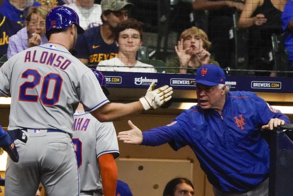 New York Mets' Pete Alonso is congratulated by manager Buck Showalter after hitting three run home run during the sixth inning of a baseball game against the Milwaukee Brewers Tuesday, Sept. 20, 2022, in Milwaukee. (AP Photo/Morry Gash)