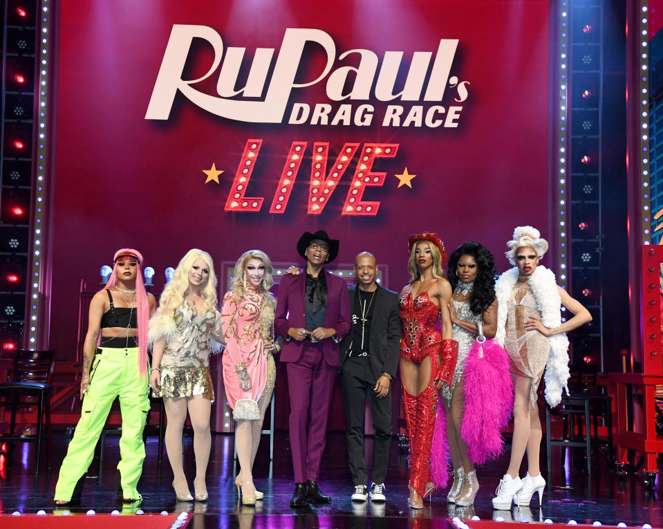 yvie oddly poses for a photo with other contestants and RuPaul onstage for RuPaul's Drag Race Live