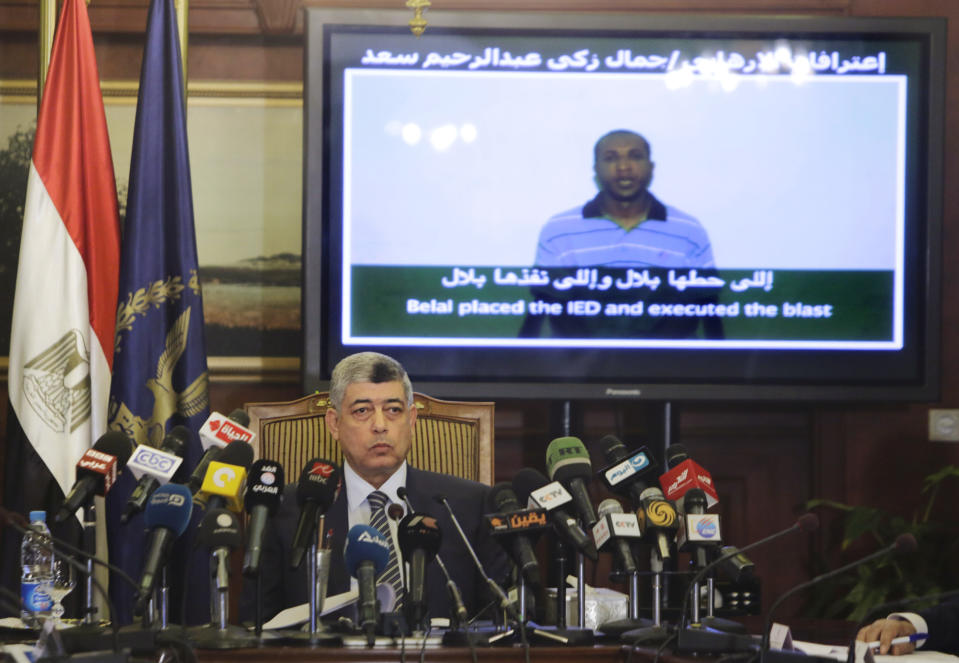 Egypt's Interior Minister Mohammed Ibrahim displays a video showing what he said was the confession of Gamal Zaki Abdel Rahim of terrorist acts, during a press conference at the interior ministry headquarters, in Cairo, Egypt, Monday, May 12, 2014. Egypt's top security official on Monday sought to build claims that the Muslim Brotherhood is backing terrorism, showing alleged confessions of militants saying they received funds from members of the group to attack police and the military. The Brotherhood says government accusations that it backs the campaign of violence are aimed at justifying authorities' drive to crush the group. (AP Photo/Amr Nabil)