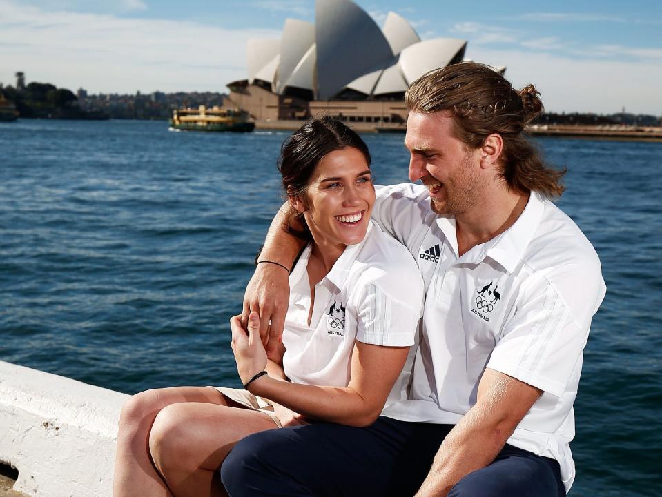 Charlotte Caslick and Lewis Holland pose outside the Sydney Opera House.