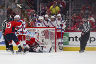 New York Rangers players celebrate after scoring against the Washington Capitals during the first period in Game 4 of an NHL hockey Stanley Cup first-round playoff series, Sunday April 28, 2024, in Washington. (AP Photo/Tom Brenner)